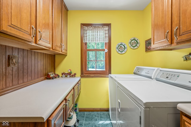 laundry room with tile flooring, cabinets, and washing machine and dryer