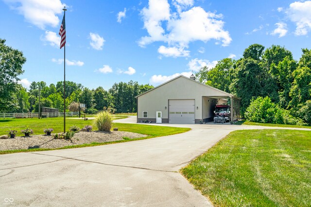 exterior space with a garage, a carport, and a yard