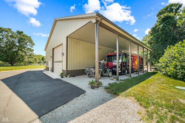 exterior space with a yard, a carport, and a garage