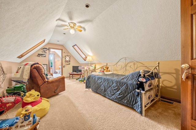 bedroom with vaulted ceiling, a textured ceiling, and carpet floors