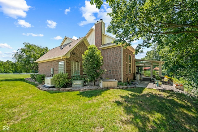 back of house featuring a lawn