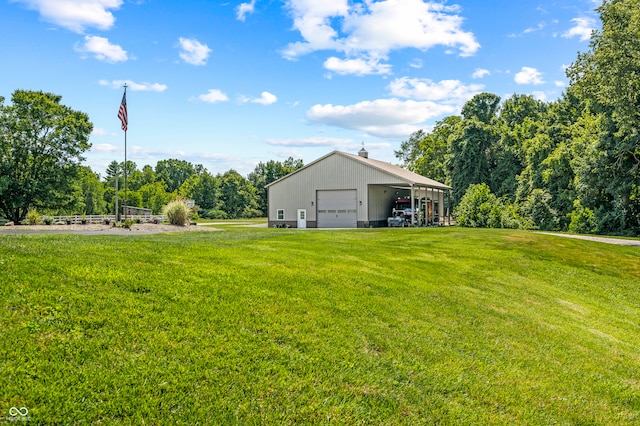 view of yard featuring a garage and an outdoor structure