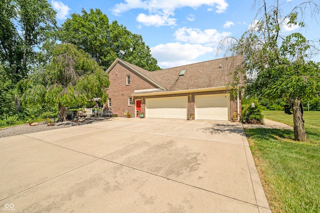 view of front of home with a front lawn and a garage