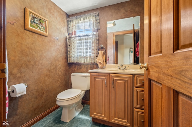 bathroom with vanity, toilet, and tile floors