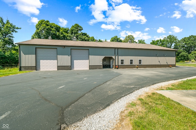 view of front of property with an outdoor structure and a garage