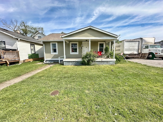 bungalow with a front yard and covered porch