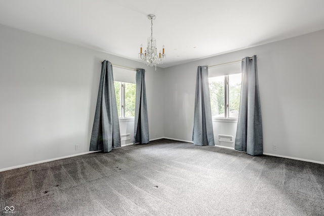 carpeted empty room with an inviting chandelier and a wealth of natural light