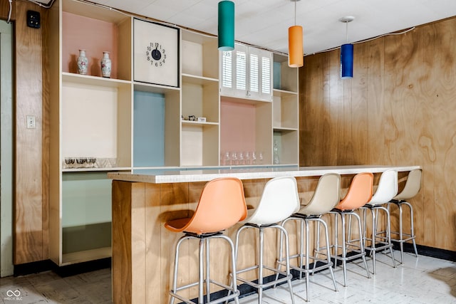 bar with wooden walls and pendant lighting