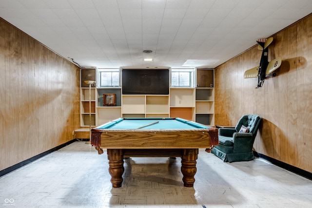 recreation room with wooden walls and pool table