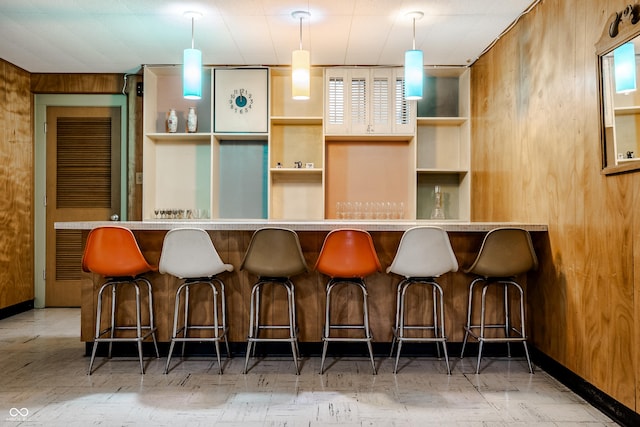 bar with wood walls and hanging light fixtures