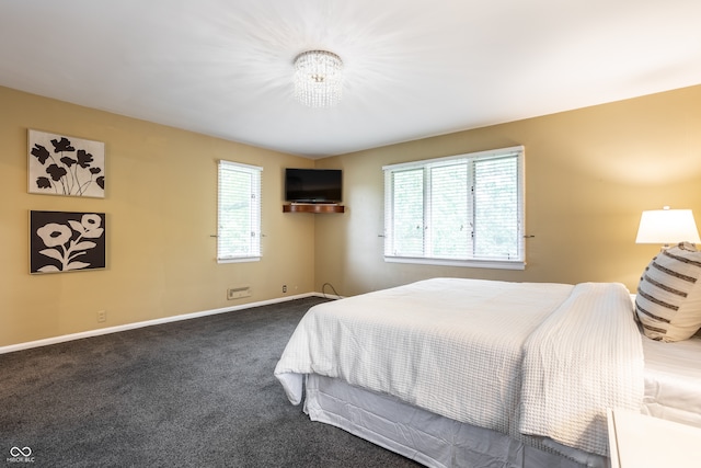 carpeted bedroom with an inviting chandelier