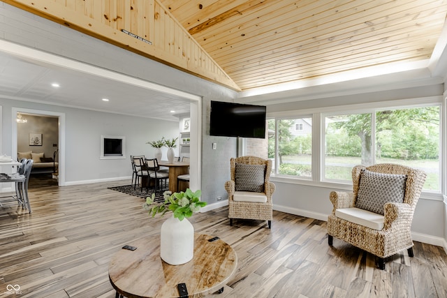 living area with a healthy amount of sunlight, wooden ceiling, lofted ceiling, and hardwood / wood-style flooring