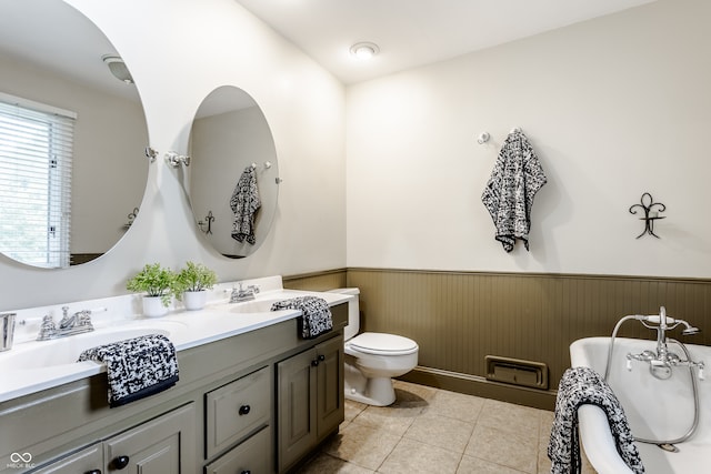 bathroom with tile patterned floors, vanity, toilet, and wood walls