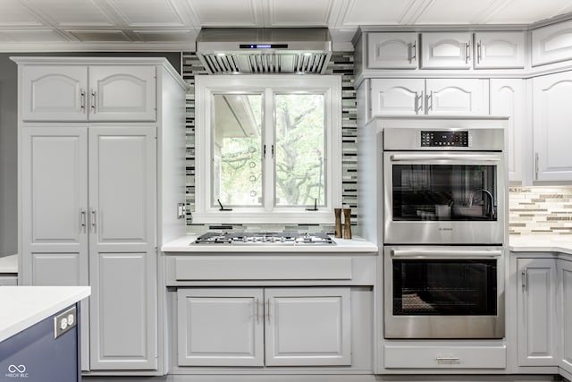 kitchen with white cabinets, stainless steel appliances, and tasteful backsplash