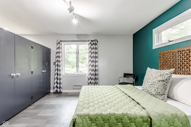 bedroom featuring rail lighting