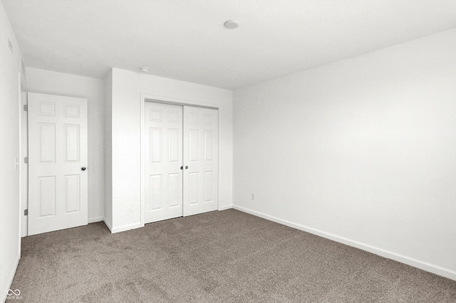 unfurnished bedroom with carpet and a closet