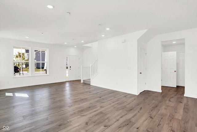 unfurnished living room with dark wood-type flooring