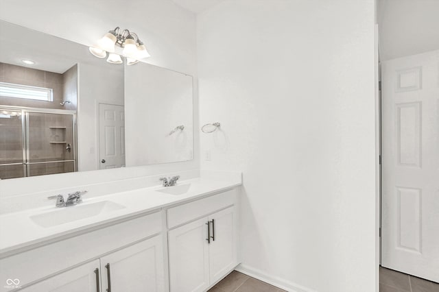 bathroom with vanity, tile patterned flooring, and a shower with door