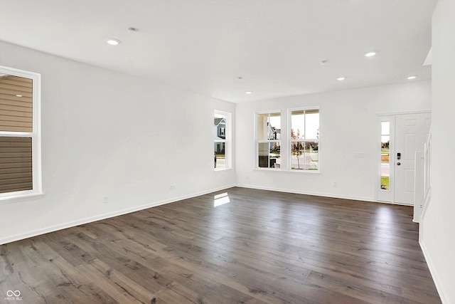 unfurnished living room featuring dark wood-type flooring