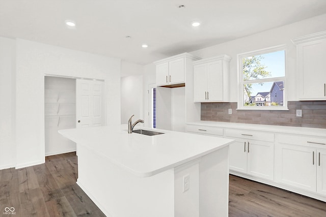 kitchen with white cabinetry, dark hardwood / wood-style flooring, and a kitchen island with sink