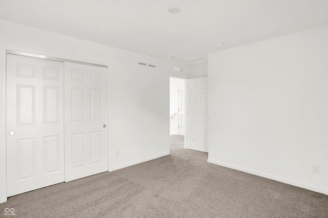 unfurnished bedroom with carpet and a closet