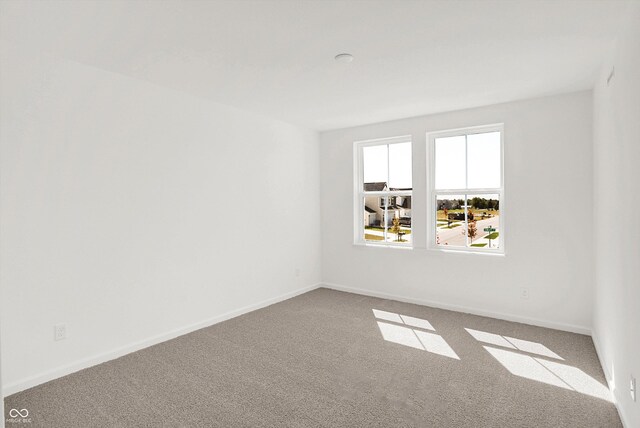 unfurnished room featuring light colored carpet