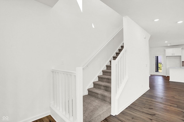 stairs with wood-type flooring