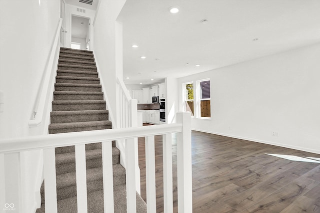 stairs with hardwood / wood-style flooring