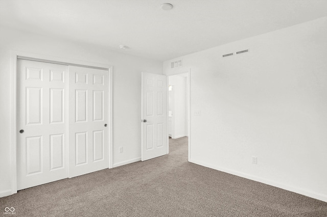 unfurnished bedroom with carpet flooring and a closet