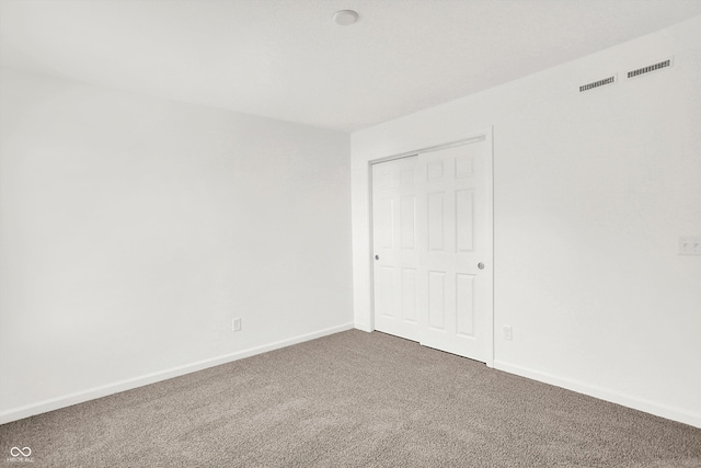 unfurnished bedroom featuring a closet and carpet