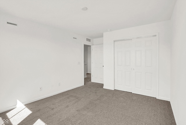 unfurnished bedroom featuring a closet and carpet floors