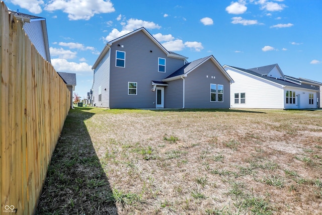 rear view of house featuring a yard