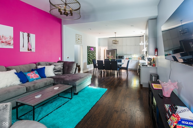 living room featuring hardwood / wood-style flooring and a chandelier