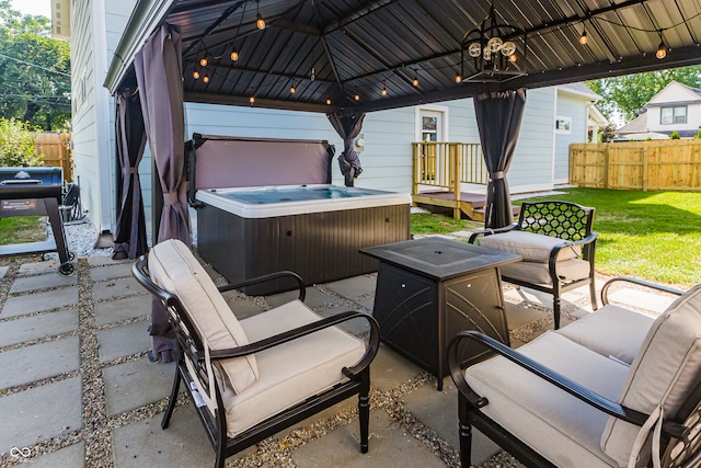 view of patio / terrace featuring a gazebo and a hot tub