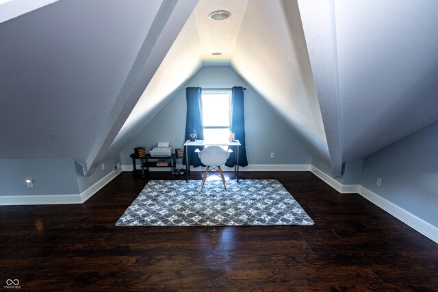 interior space featuring dark hardwood / wood-style flooring and vaulted ceiling