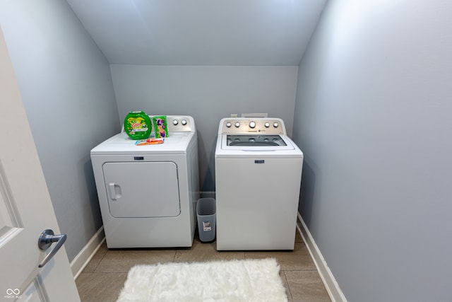 clothes washing area featuring washing machine and clothes dryer and light tile patterned floors