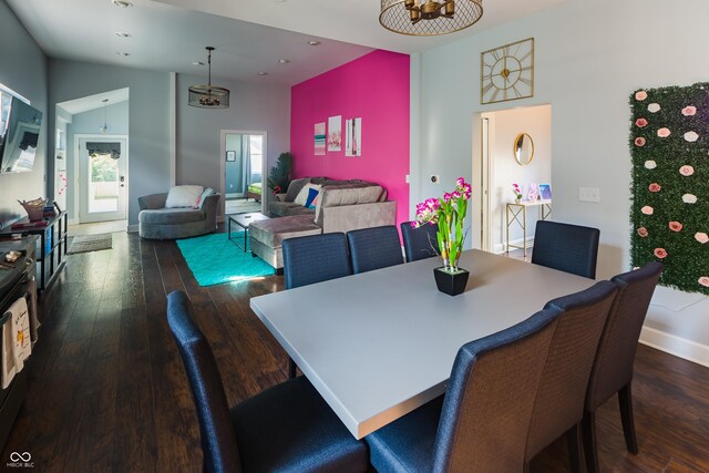 dining room with vaulted ceiling and dark wood-type flooring