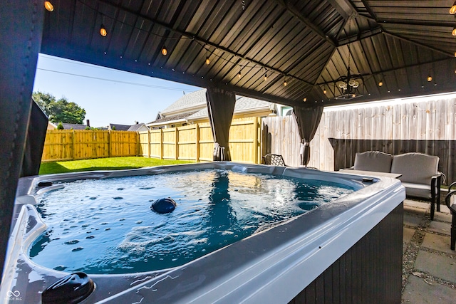 view of pool with a gazebo and a hot tub