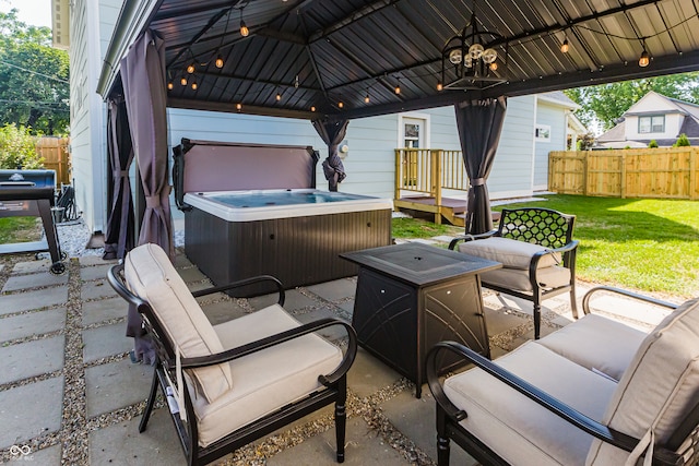 view of patio / terrace with an outdoor hangout area, a gazebo, and a hot tub