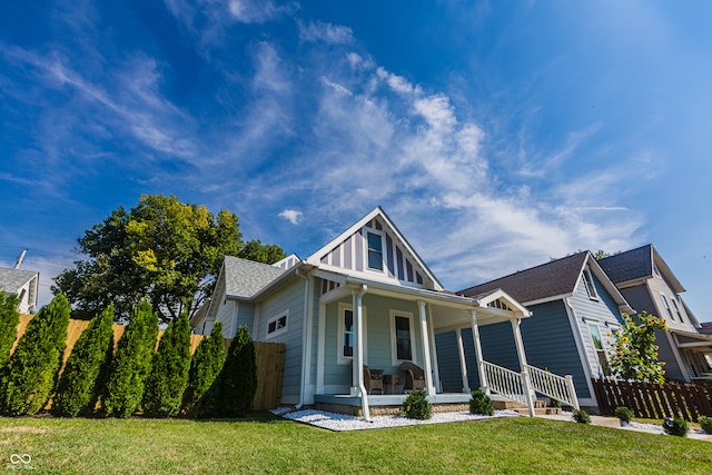 view of front of home with a porch and a front yard