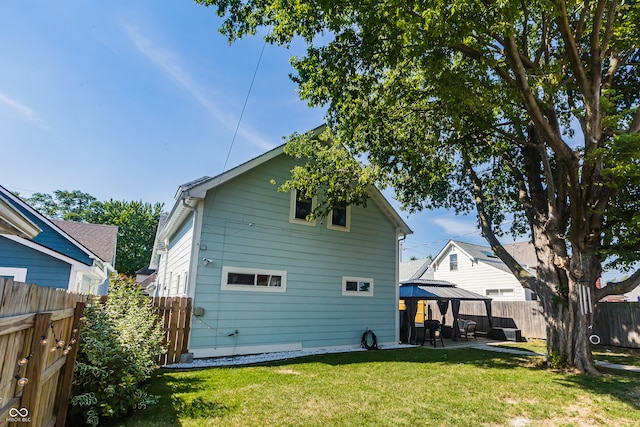 rear view of property featuring a patio and a yard