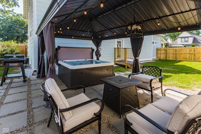 view of patio / terrace with a hot tub, a gazebo, and outdoor lounge area