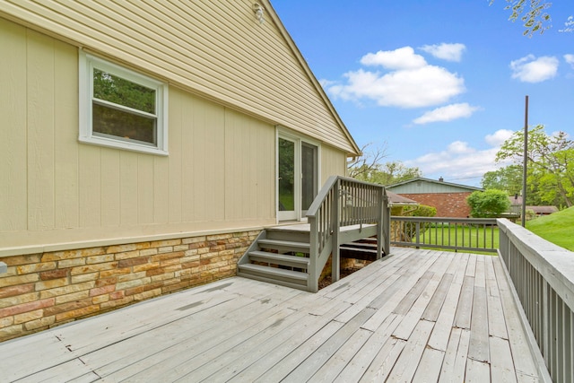 wooden terrace featuring a lawn