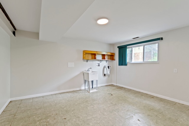 interior space featuring light tile patterned flooring and washer hookup