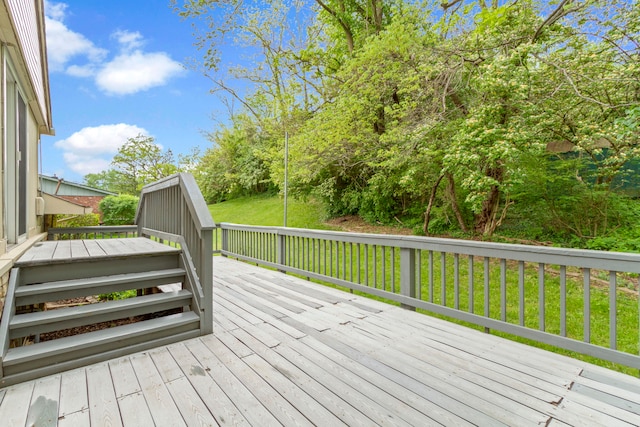 wooden terrace with a lawn