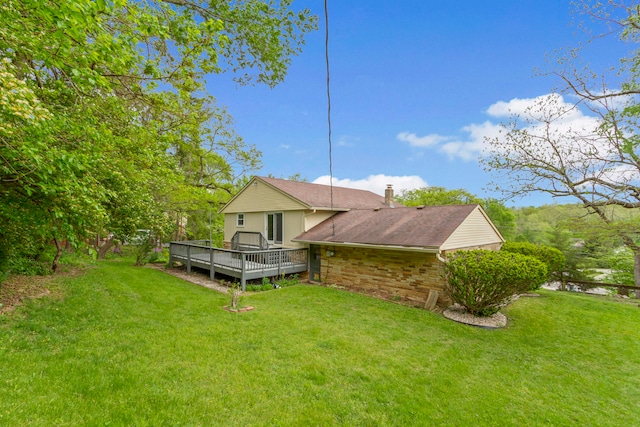 view of home's exterior with a lawn and a deck