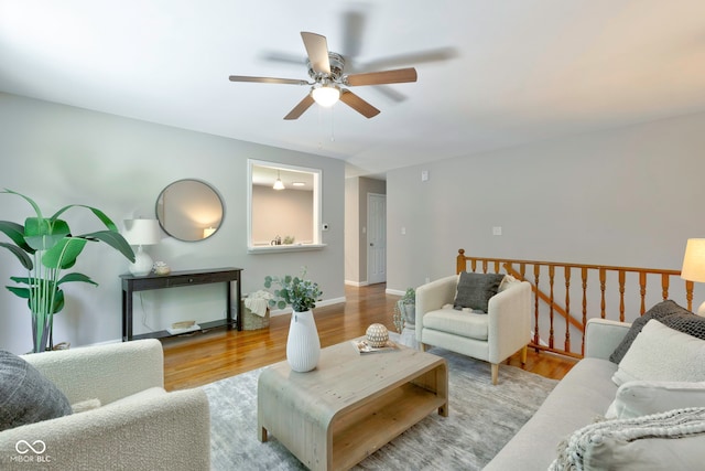 living room featuring ceiling fan and hardwood / wood-style floors