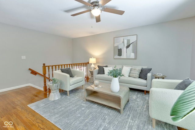 living room featuring ceiling fan and hardwood / wood-style flooring