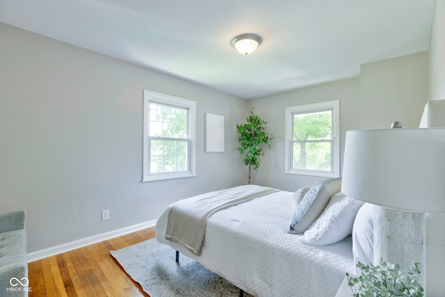 bedroom featuring hardwood / wood-style flooring and multiple windows