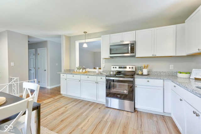 kitchen featuring light wood-type flooring, stainless steel appliances, and white cabinetry